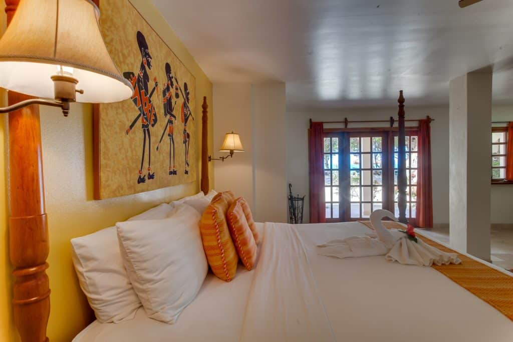 Sideview of the master bedroom with a king sized bed inside the One Bedroom Beachfront Suites at The Colonial Inn