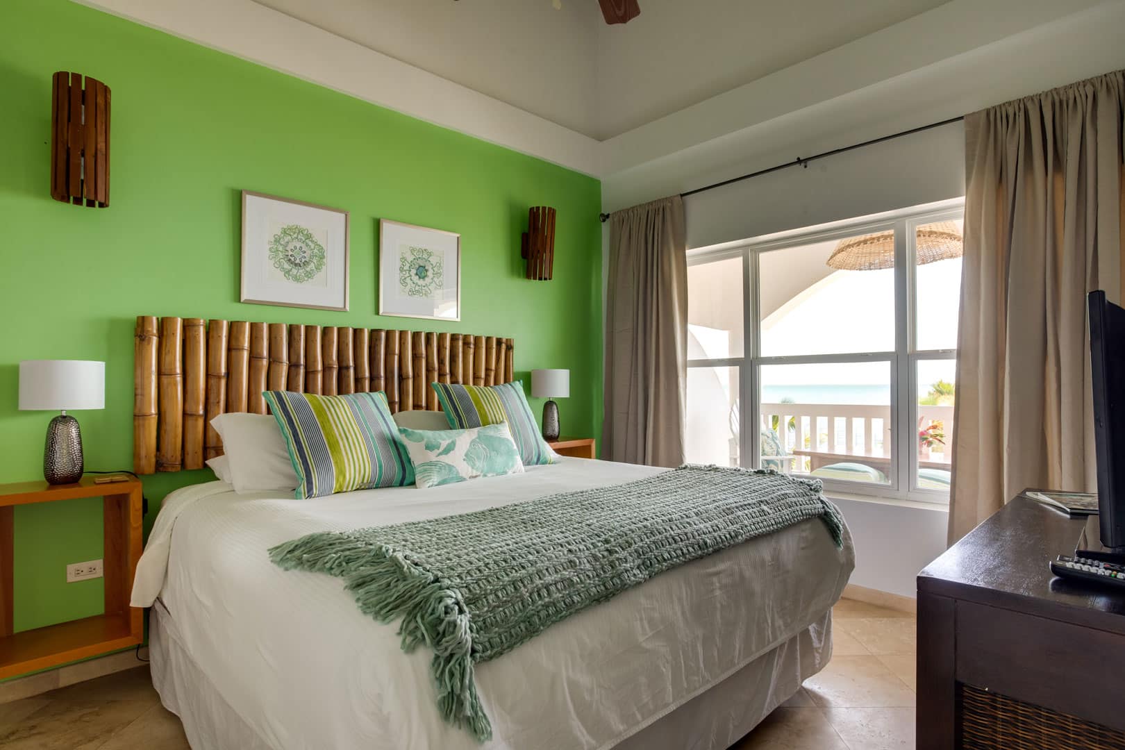 The master bedroom with a king sized bed with pillows and linen inside of the 1 Bedroom Beachfront at Umaya Resort & Adventure