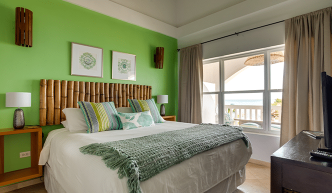 The master bedroom with a king sized bed inside of the 2 Bedroom Penthouse Beachfront at Umaya Resort & Adventure