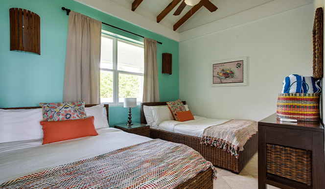 The guest bedroom with two queen sized beds inside the 2 Bedroom Penthouse Beachfront at Umaya Resort & Adventure