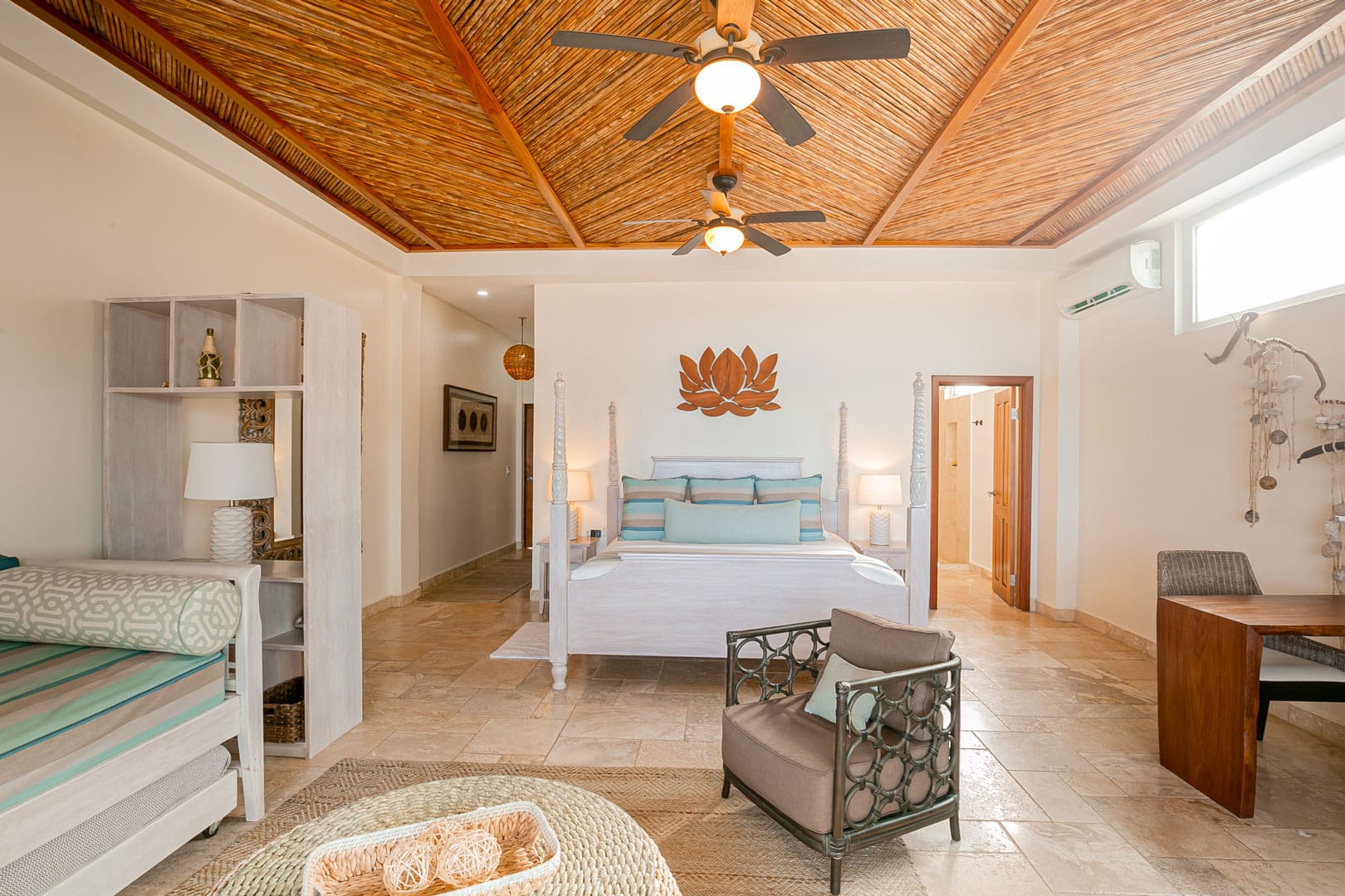 Master bedroom with a queen sized bed that has pillows and linen inside of the Beachfront Spa Rooms at The Resort at Almond Beach