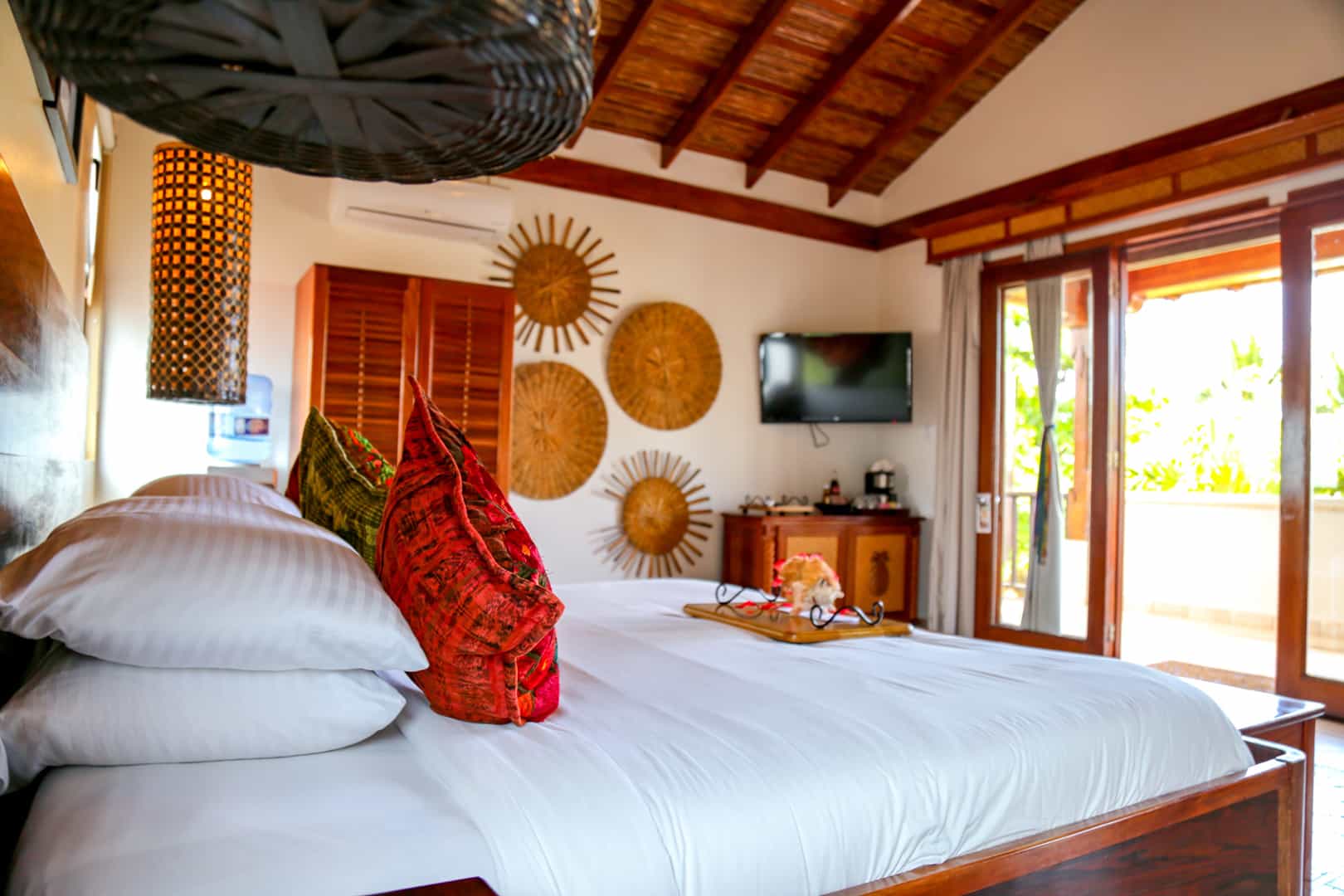 Master bedroom with a queen sized bed with pillows and linen inside the Seaview Deluxe Rooms at The Resort at Almond Beach