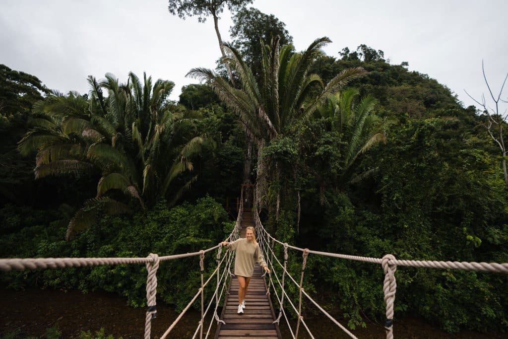 A guest standing on the rope bridge at The Rainforest Lodge at Sleeping Giant Resort